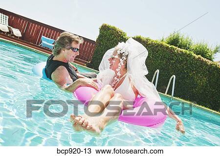 Bride and groom in swimming pool View Large Photo Image Stock Image - Bride and groom in swimming pool. Fotosearch