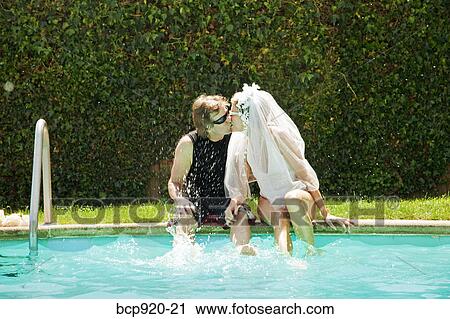 Bride and groom in swimming pool View Large Photo Image Stock Image - Bride and groom in swimming pool. Fotosearch