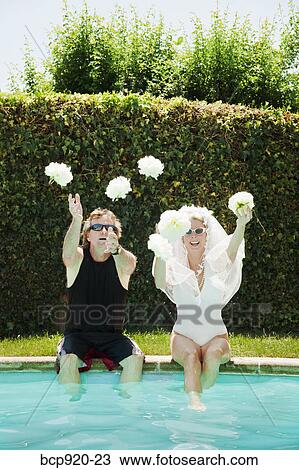 Bride and groom in swimming pool View Large Photo Image Stock Image - Bride and groom in swimming pool. Fotosearch