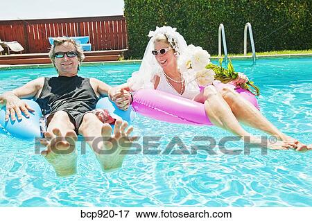 Bride and groom in swimming pool View Large Photo Image Stock Photo - Bride and groom in swimming pool. Fotosearch