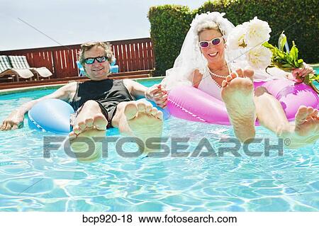 Bride and groom in swimming pool View Large Photo Image Stock Photo - Bride and groom in swimming pool. Fotosearch