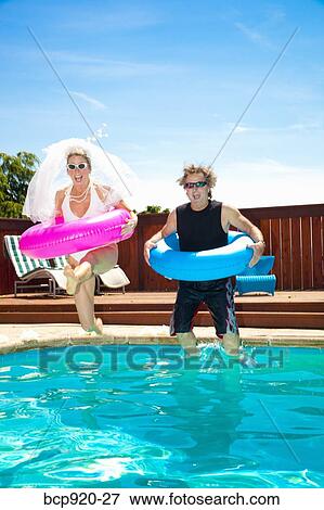 Bride and groom in swimming pool View Large Photo Image Stock Photo - Bride and groom in swimming pool. Fotosearch
