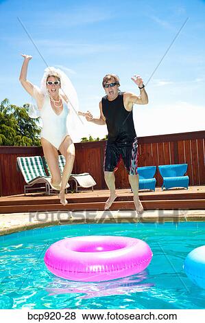 Bride and groom in swimming pool View Large Photo Image Stock Photo - Bride and groom in swimming pool. Fotosearch