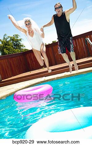 Bride and groom in swimming pool View Large Photo Image Stock Photo - Bride and groom in swimming pool. Fotosearch