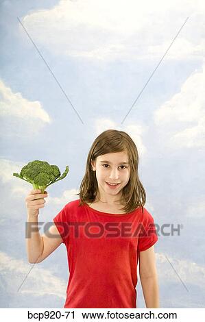 Child holding broccoli View Large Photo Image Stock Image - Child holding broccoli. Fotosearch