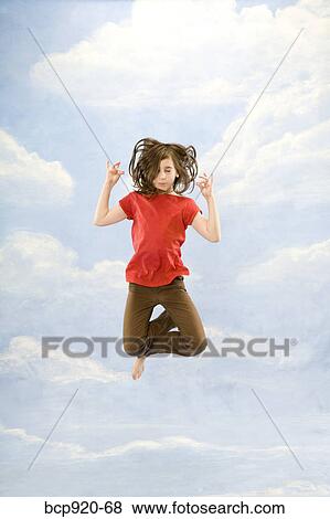 Child jumping in air View Large Photo Image Stock Photo - Child jumping in air. Fotosearch