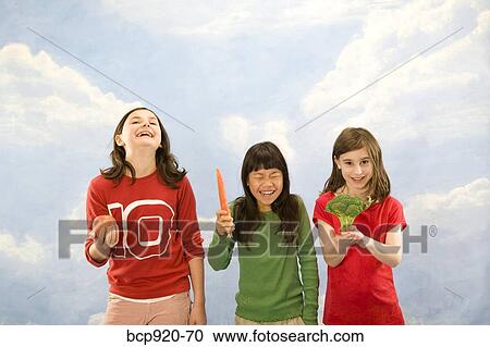 Stock Image - Children holding different foods. Fotosearch