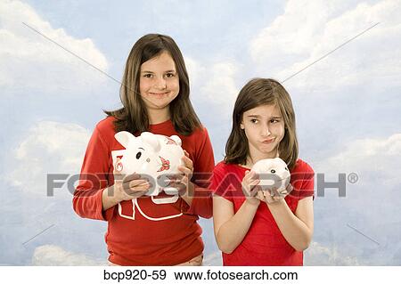 Stock Photo - Children holding piggy banks. Fotosearch