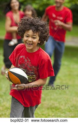 Stock Image - Family running in park. Fotosearch