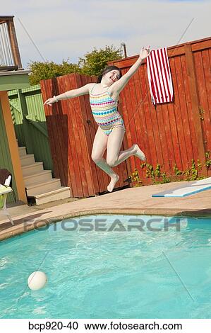 Girl jumping into pool View Large Photo Image Stock Image - Girl jumping into pool. Fotosearch