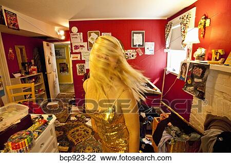 Teen girl dressing up in messy room View Large Photo Image Stock Image - Teen girl dressing up in messy room. Fotosearch
