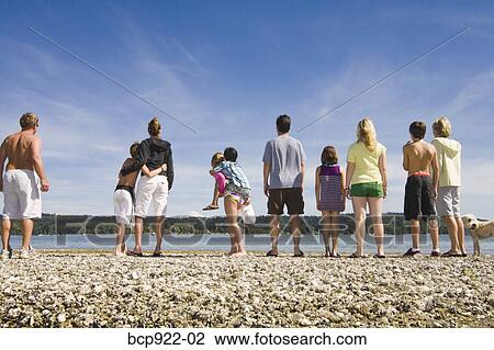 Stock Image - Three generations of family on beach. Fotosearch