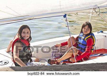Two girls sailing small boat View Large Photo Image Picture - Two girls sailing small boat. Fotosearch