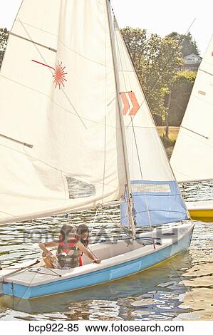 Two girls sailing small boat View Large Photo Image Stock Photography - Two girls sailing small boat. Fotosearch