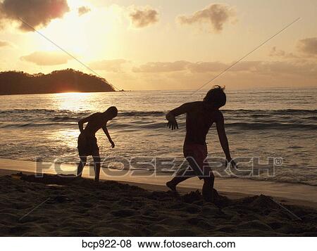 Two people on the beach View Large Photo Image Stock Photo - Two people on the beach. Fotosearch