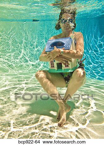Woman diving after sinking house View Large Photo Image Picture - Woman diving after sinking house. Fotosearch