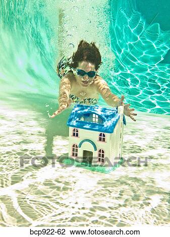 Woman diving after sinking house View Large Photo Image Stock Image - Woman diving after sinking house. Fotosearch