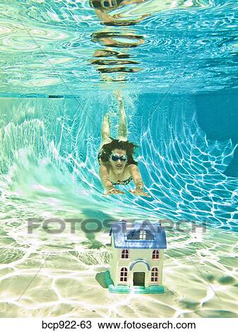 Stock Image - Woman diving after sinking house. Fotosearch