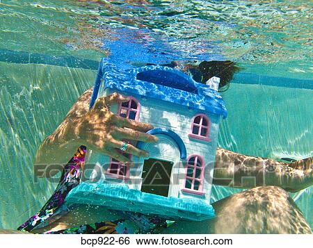 Woman diving after sinking house View Large Photo Image Stock Photograph - Woman diving after sinking house. Fotosearch