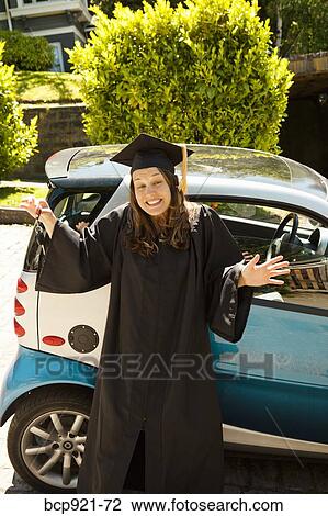 Woman in cap and gown with smart car View Large Photo Image Stock Image - Woman in cap and gown with smart car. Fotosearch