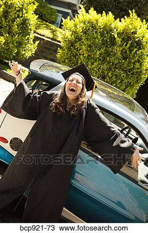 Woman in cap and gown with smart car View Large Photo Image Stock Image - Woman in cap and gown with smart car. Fotosearch
