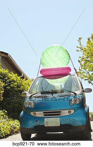Woman with beach ball on smart car View Large Photo Image Stock Image - Woman with beach ball on smart car. Fotosearch