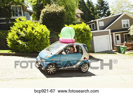Woman with beach ball on smart car View Large Photo Image Stock Photo - Woman with beach ball on smart car. Fotosearch
