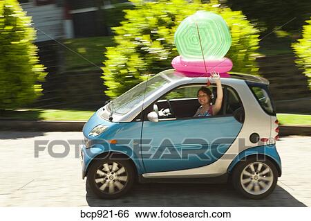 Woman with beach ball on smart car View Large Photo Image Stock Photograph - Woman with beach ball on smart car. Fotosearch