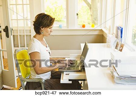 Woman working in home office View Large Photo Image Stock Photo - Woman working in home office. Fotosearch