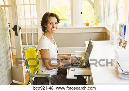 Woman working in home office View Large Photo Image Stock Photo - Woman working in home office. Fotosearch