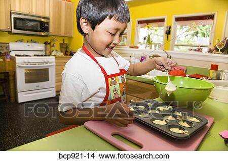 Young boy making cupcakes View Large Photo Image Picture - Young boy making cupcakes. Fotosearch