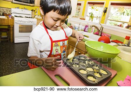 Young boy making cupcakes View Large Photo Image Stock Image - Young boy making cupcakes. Fotosearch