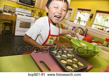 Young boy making cupcakes View Large Photo Image Stock Image - Young boy making cupcakes. Fotosearch