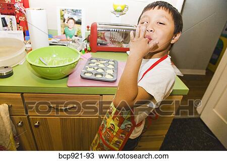 Young boy making cupcakes View Large Photo Image Stock Image - Young boy making cupcakes. Fotosearch