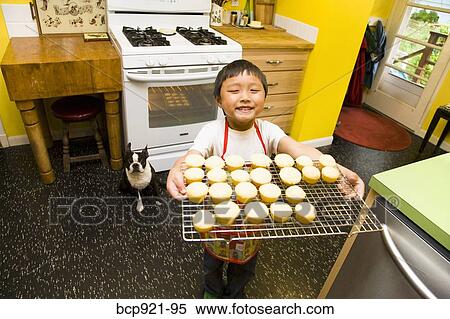 Young boy making cupcakes View Large Photo Image Stock Photography - Young boy making cupcakes. Fotosearch