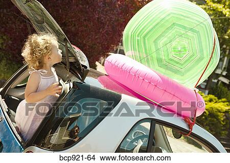 Young girl in back of smart car View Large Photo Image Picture - Young girl in back of smart car. Fotosearch