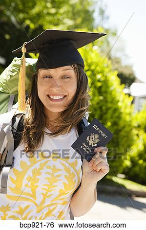 Stock Photograph - Young woman with backpack and passport. Fotosearch