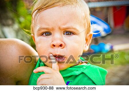 Stock Photo - baby with quizzical expression. Fotosearch