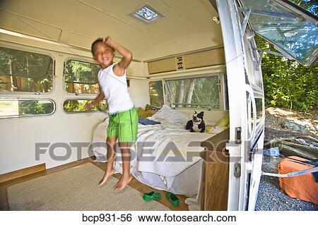Boy and dog on bed in camper View Large Photo Image Stock Photograph - Boy and dog on bed in camper. Fotosearch