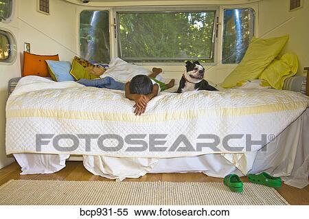 Boy and dog on bed in camper View Large Photo Image Stock Photography - Boy and dog on bed in camper. Fotosearch