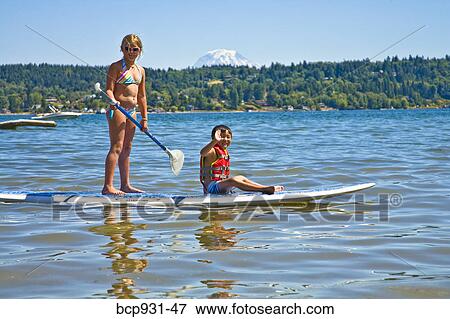 boy and girl on paddle board View Large Photo Image Stock Photo - boy and girl on paddle board. Fotosearch