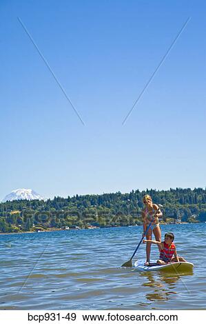 boy and girl on paddle board View Large Photo Image Stock Photo - boy and girl on paddle board. Fotosearch