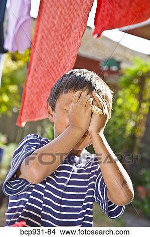 boy on chaise under clotheslines View Large Photo Image Picture - boy on chaise under clotheslines. Fotosearch