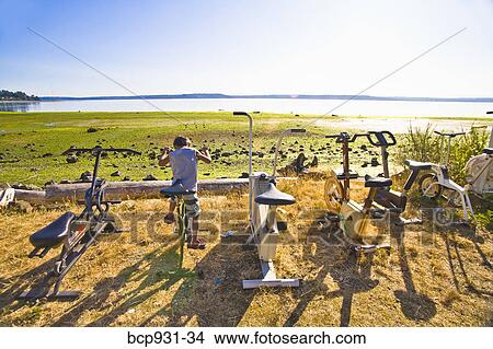 boy on exercise bike next to beach View Large Photo Image Picture - boy on exercise bike next to beach. Fotosearch