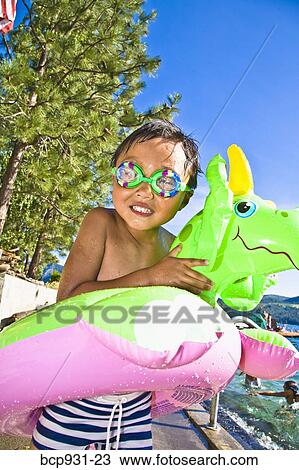 boy with dragon floatie and goggles View Large Photo Image Stock Image - boy with dragon floatie and goggles. Fotosearch