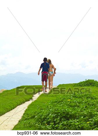 Stock Photograph - children walking down path to beach. Fotosearch