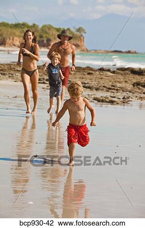 family running on beach in mexico View Large Photo Image Stock Image - family running on beach in mexico. Fotosearch