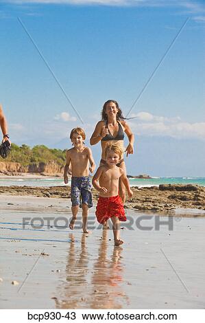 family running on beach in mexico View Large Photo Image Stock Image - family running on beach in mexico. Fotosearch