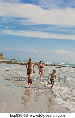 family running on beach in mexico View Large Photo Image Stock Image - family running on beach in mexico. Fotosearch