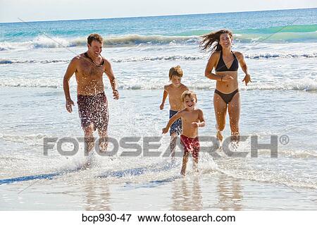 family running on beach in mexico View Large Photo Image Stock Photo - family running on beach in mexico. Fotosearch